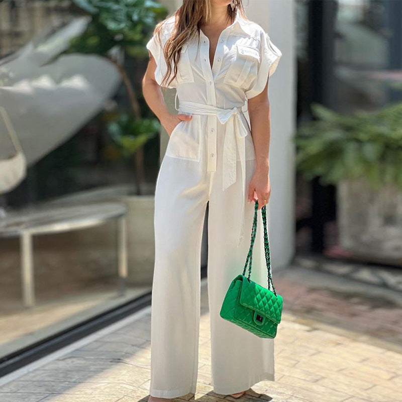 Sima színű hajtókás galléros jumpsuit, rövid ujjú, gombos, zsebes, derék